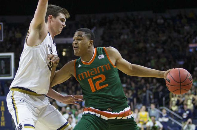 Miami's James Palmer (12) gets pressure from Notre Dame's Steve Vasturia (32) during the first half of Miami's 68-50 win in an NCAA college basketball game Wednesday, March 2, 2016, in South Bend, Ind. (AP Photo/Robert Franklin)