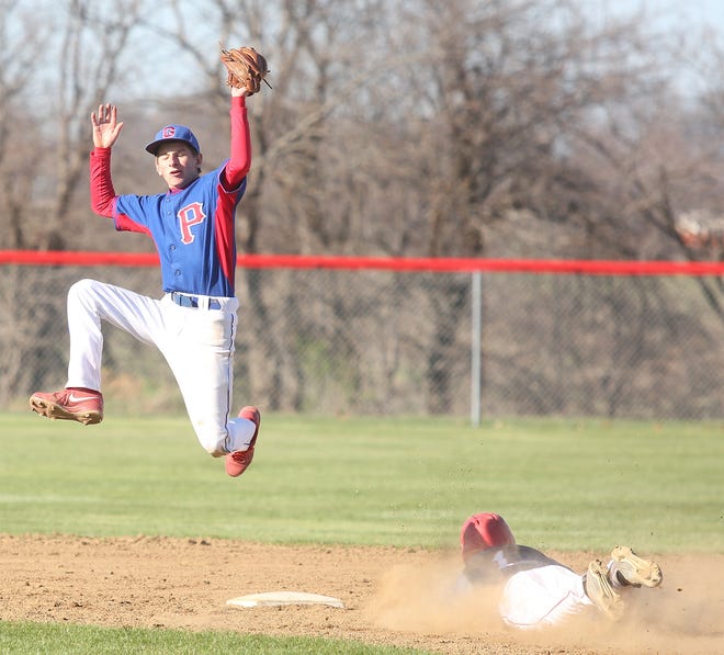Garaway second baseman Ben Koshmider jumps for the throw to second base as Dover's Maguire Morris slides for a stolen base during the game Tuesday at Sugarcreek.