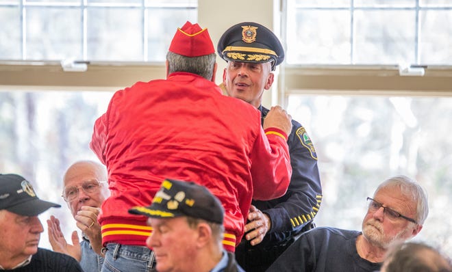 Forrest Thorpe Jr hugs Yarmouth Deputy Police Chief Lt. Steven Xiarhos. PHOTO BY ALAN BELANICH