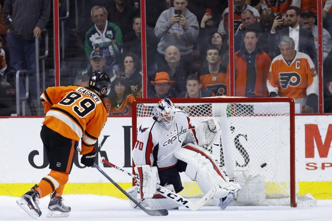 Philadelphia Flyers' Sam Gagner scores a goal past Washington goalie Braden Holtby during a shootout Wednesday, March 30, 2016, in Philadelphia. Philadelphia won 2-1 in a shootout.