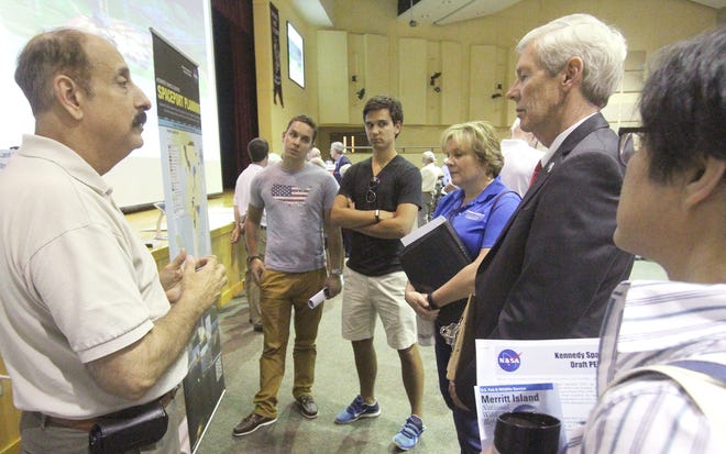 Mario Busacca, at left, Chief Kennedy Space Center Spaceport Planning Officer, talks with visitors about the space center's 20-year plan during a presentation Wednesday in New Smyrna Beach.  News-Journal/David Tucker