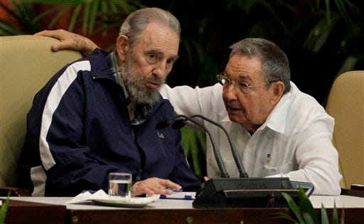 FILE - In this April 19, 2011 file photo, Fidel Castro, left, and Cuba's President Raul Castro talk during the 6th Communist Party Congress in Havana, Cuba. Some party members are calling for the April 2016 congress to be postponed to allow public debate about the governmentís plans to continue market-oriented reforms of Cubaís centrally controlled economy. (AP Photo/Javier Galeano, File)