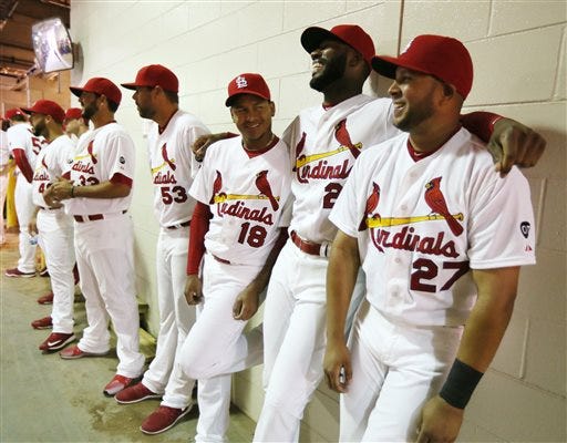 St. Louis Cardinals players Carlos Martinez (18), Jason Heyward, second from right, and Jhonny Peralta, right, wait with teammates under the stands for player introductions for the Cardinals' home-opener baseball game against the Milwaukee Brewers, Monday, April 13, 2015, in St. Louis. The Brewers won 5-4. (Chris Lee/St. Louis Post-Dispatch via AP)