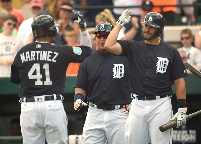 Detroit's Victor Martinez (41) is congratulated by Miguel Cabrera, center, and J.D. Martinez, right, after hitting a two-run home run during their game against the New York Yankees at Joker Marchant Stadium in Lakeland on Thursday. J.D. Martinez hit one of his three home runs in the next at-bat.