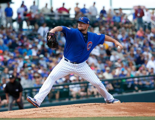 Chicago Cubs pitcher Jon Lester throws during the first inning of a spring training baseball game against the Colorado Rockies, Wednesday, March 30, 2016, in Mesa, Ariz. (AP Photo/Matt York)