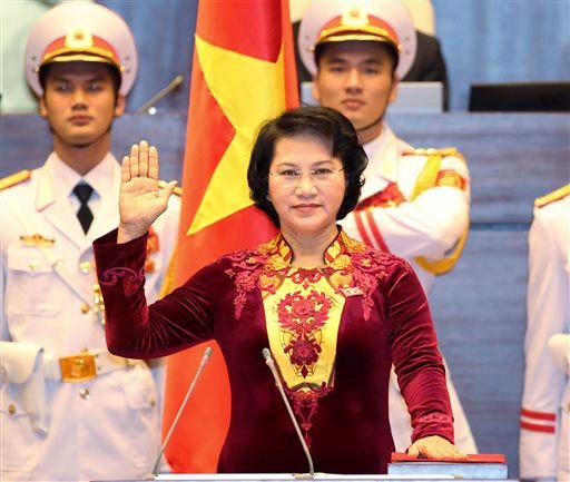 Nguyen Thi Kim Ngan takes the oath of office after being elected as chairwoman of the National Assembly in Hanoi, Vietnam Thursday, March 31, 2016. Vietnam's parliament on Thursday elected Ngan as its chairwoman, making her the first woman to lead the Communist-dominated legislature. (Thong Nhat/Vietnam News Agency via AP)