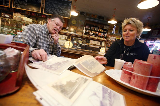 Photo by Daniel Freel/New Jersey Herald - Bob and Megan Horst, owners of the Hainesville General Store in Sandyston, look over old newspaper clippings chronicling the history of the store. The couple has owned the store, which was built in 1883, for 20 years.