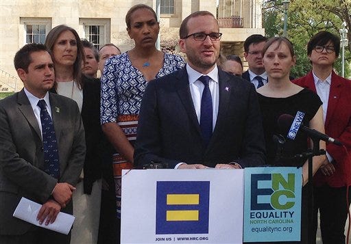 Human Rights Campaign Executive Director Chad Griffin, center, speaks at a news conference at the old state Capitol Building in Raleigh, N.C. on Thursday, March 30, 2016. Griffin, Equality North Carolina Executive Director Chris Sgro, far left, and others delivered a letter to Gov. Pat McCrory signed by more than 100 corporate executives calling for repeal of a law limiting bathroom options for transgender people and prohibiting local anti-discrimination measures providing protections on the basis of sexual orientation and gender identity. (AP Photo/Gary Robertson)