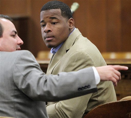 FILE - In this Jan. 23, 2014, file photo, former Baylor football player Tevin Elliott waits with a unidentified lawyer in a McLennan county courtroom in Waco, Texas. A woman has filed a federal lawsuit against Baylor University contending that the largest Baptist school in the country was "deliberately indifferent" to sexual assault allegations against a former football player. The lawsuit alleges that Baylor failed to act against Tevin Elliott despite receiving six complaints from women claiming he assaulted them. (Jerry Larson/Waco Tribune Herald via AP, File)