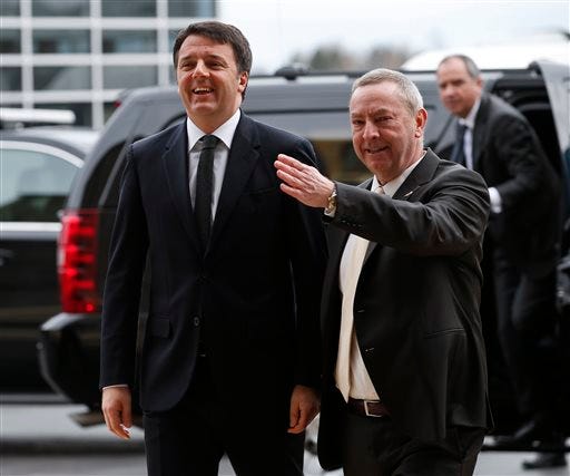 FILE - Italy's Prime Minister Matteo Renzi, left, arrives at Fermi National Accelerator Laboratory for a tour in Batavia, Ill., Wednesday, March 30, 2016. Renzi will deliver an address at Harvard University as he continues a four-day U.S. visit. Renzi is scheduled to speak on Thursday after first touring an IBM research facility in Cambridge. (AP Photo/Kamil Krzaczynski, File)