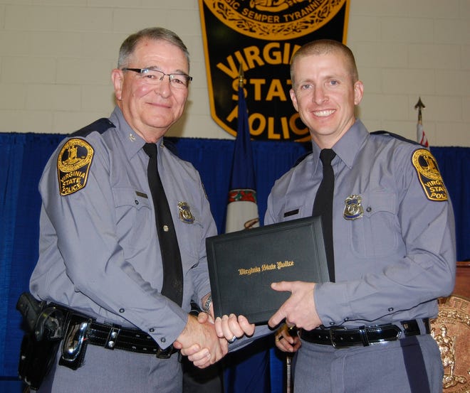 In this November 2014 photo provided by the Virginia State Police, trooper Chad P. Dermyer poses for a photo as he receives his graduation diploma from Superintendent Col. W. Steven Flaherty. Virginia State Police Superintendent Col. Steven Flaherty says Dermyer, died Thursday, March 31, 2016 after being shot multiple times responding to a call at a Greyhound bus station in Richmond. The gunman was shot dead by two other troopers. (Virginia State Police via AP)