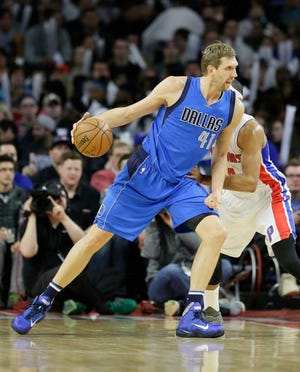 Mavericks forward Dirk Nowitzki drives on Pistons forward Tobias Harris.The win moved Dallas a half-game ahead of Utah in the Western Conference.