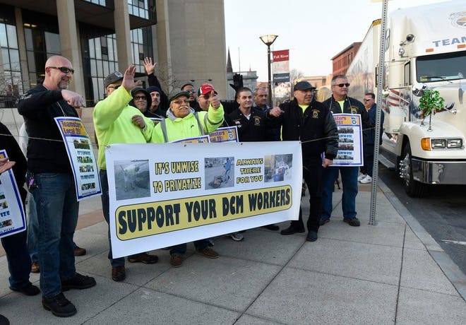 Teamsters Local 251 members react to a beeping horn as they gather for an informational picketing rally in March outside Fall River Government Center on Tuesday, before the City Council. In the middle of this photo, giving the thumbs-up, is Fall River DCM worker Bob Tavares.