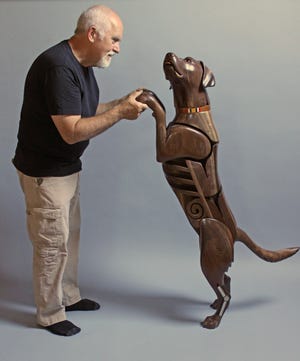 Photo courtesy Canton Museum of Art

James Mellick meets his creation, Wounded Warrior Dog Number 4. The Chocolate Labrador has the Iraq war service ribbon on its collar. The Labrador is often used for sniffing out bombs and other explosive devices.