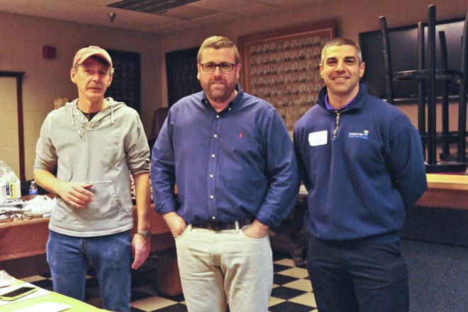 They're at it again. Finger Lakes Dental Care owner Dr. Jason Tanoory, right; chef Duane "Gilligan" Dickinson, left; and Eric's Office and Greenfront owner Eric Zimmerman, center — pictured during a community harvest meal in November — are putting on a community meal, scheduled for Monday. MELODY BURRI/MESSENGER POST FILE PHOTO