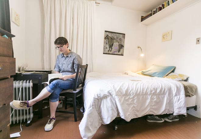 Megan Walsh, an Airbnb customer from Chicago, reads in a room she rented at a Los Angeles home during a stay in 2014. Millennials such as Walsh have been turning to Airbnb more frequently rather than renting rooms from conventional hotels. AP files/Damian Dovarganes