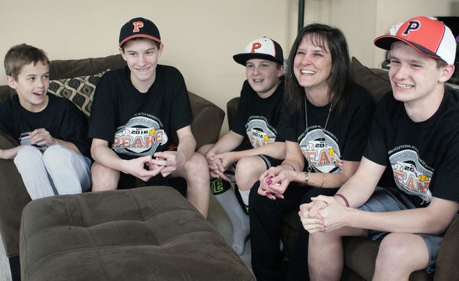 The Peake family (from left), Justin, 9, Zach, 15, Brandon, 12, Kathy and Dominick, 17, remember all the good times with their father, husband and coach, Arty, at their Lower Makefield home Thursday, March 31, 2016. The Peake family lost Arty last year to cancer.