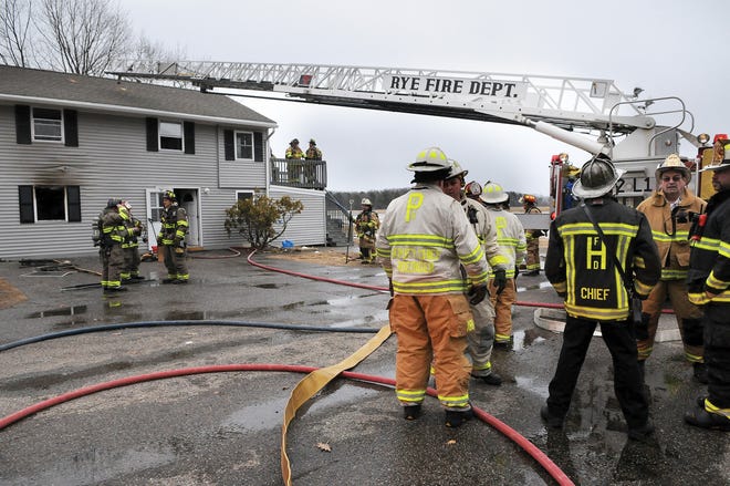 Firefighters work at the scene of a fire at 277 Pioneer Road in Rye in 2014. A proposal for Rye to share Portsmouth's fire chief drew pushback and calls for further study. Photo by Deb Cram/Seacoastonline