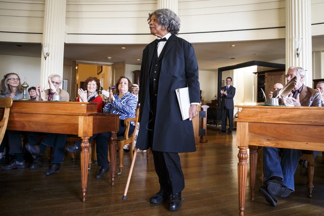 Bob Davis, a historian and Frederick Douglass re-enactor, enters Representative Hall as Frederick Douglass to deliver a monologue on the 150th anniversary of Douglass´ speech, the first by an African-American in the Illinois Capitol in April 1866, during an event at the Old State Capitol State Historic Site, Sunday, April 3, 2016, in Springfield, Ill. Justin L. Fowler/The State Journal-Register