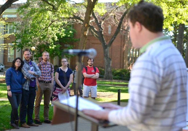 A crowd gathers to listen as Assistant Professor Peter O'Connell reads from Homer's "The Odyssey" during a Homerathon sponsored by the Department of Classics in front of the Library on Monday, April 4, 2016 in Athens, Ga.  (Richard Hamm/Staff) OnlineAthens / Athens Banner-Herald
