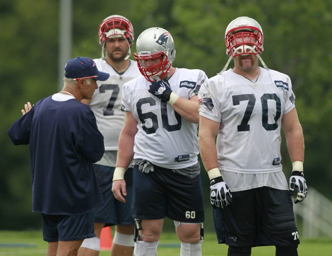 Offensive line coach Dante Scarnecchia (left) instructs linemen, from left, Sebastian Vollmer, Rich Ohrnberger and Logan Mankins during a 2011 training camp practice. After two years away, Scarnecchia returns as the offensive line coach for 2016. AP File Photo/Michael Dwyer