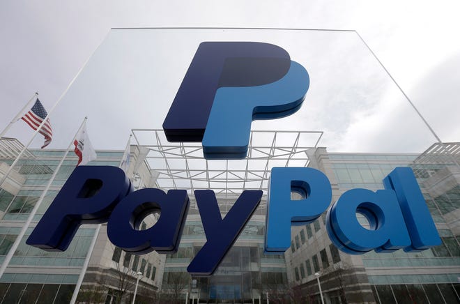 FILE - This March 10, 2015, file photo, shows signage outside PayPal's headquarters in San Jose, Calif. PayPal said on Tuesday, April 5, 2016, it's canceling plans to bring 400 jobs to North Carolina after lawmakers passed a law that restricts protections for lesbian, gay, bisexual and transgender people. (AP Photo/Jeff Chiu, File)