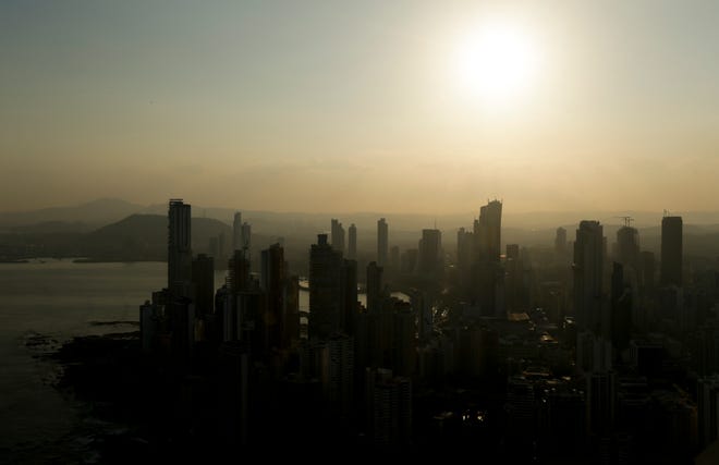 Panama City skyline is silhouette at sunset in Panama, Monday, April 4, 2016. Panama's president says his government will cooperate "vigorously" with any judicial investigation arising from the leak of a vast trove of information on the offshore financial dealings of the world's rich and famous. An international coalition of media outlets Sunday published investigations it said stemmed from the leak of 115 million records kept by the Panama-based law firm Mossack Fonseca on behalf of clients. (AP Photo/Arnulfo Franco)