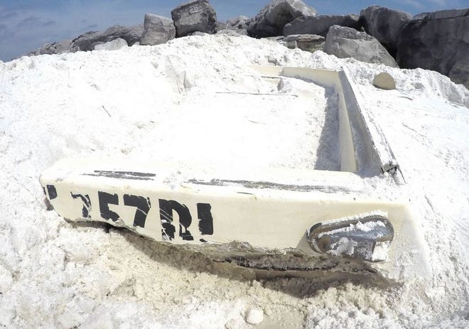 On Monday, Destin resident Rebecca Stearns literally tripped over this boat buried in the sand near the East Jetty. She spent more than an hour trying to uncover it.