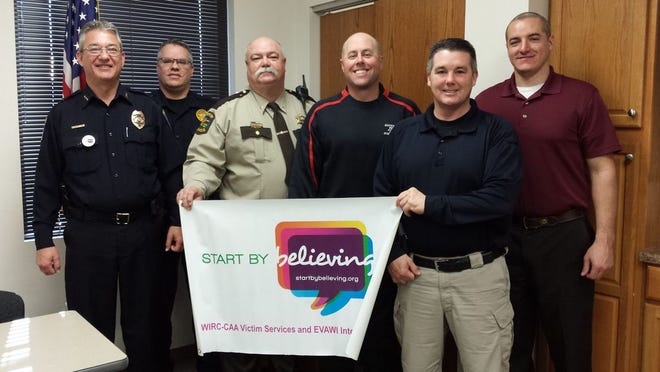 The Monmouth Police Department and Warren County Sheriff's Office come together to show support for the nationwide Start By Believing campaign, a public awareness campaign aimed at helping victims of sexual assault and domestic violence. From left: Chief of Police Bill Feithen, Sergeant Joe Bratcher, Sheriff Martin Edwards, Investigator Terry Hepner, Lieutenant Jerry Kinney and Investigator Brandon Blackman.