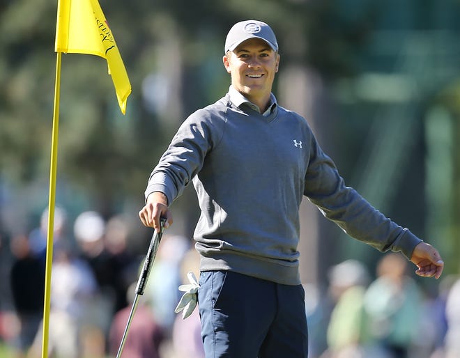 Defending Masters champion Jordan Spieth smiles while putting on the third hole during a practice round in Augusta, Ga., on Tuesday. AP Photo