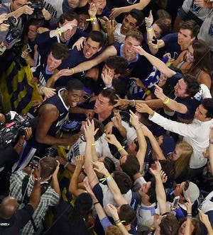 Villanova forward Kris Jenkins celebrate with fans after the NCAA Final Four tournament college basketball championship game against North Carolina, Monday, April 4, 2016, in Houston. Villanova won 77-74.