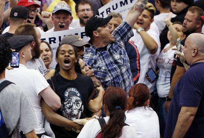 FILE - In this March 19, 2016, file photo, protesters shout as they are removed from the venue as Republican presidential candidate Donald Trump speaks during a campaign rally in Tucson, Ariz. As confrontational and occasionally violent protests become commonplace at Trump's campaign events, opponents of the brash billionaire worry they'll start to overshadow his fiery rhetoric and the sometimes rough way his campaign handles dissent, and become a rallying cry among his supporters and those on the fence about whether to back his candidacy. (AP Photo/Ross D. Franklin, File)
