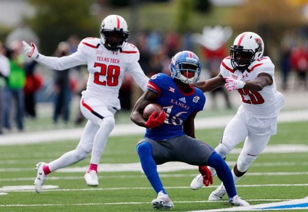 Texas Tech defensive backs Paul Banks III and Tevin Madison close in to tackle Kansas wide receiver Steven Sims Jr. on Saturday, Oct. 17, 2015, at Memorial Stadium in Lawrence, Kansas.