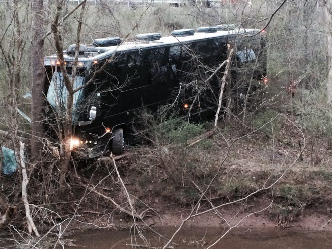 A tour bus for musician Gregg Allman's band rests against a tree near a creek after veering off Interstate 77 Wednesday morning, April 6, 2016, near Goldtown, W.Va. A tour spokesman for Allman's band says three crew members have been injured. The bus was headed to a concert Wednesday at the Clay Center in Charleston, about 20 miles south of Goldtown. Clay Center spokeswoman LeAnn Cain said the concert is still on. Allman wasn't on the bus. (John Green/WSAZ-TV via AP) CHARLESTON (W.VA.)
