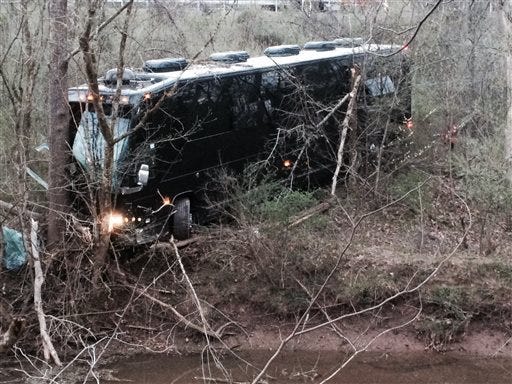 tour bus for musician Gregg Allman's band rests against a tree near a creek after veering off Interstate 77 Wednesday morning, April 6, 2016, near Goldtown, W.Va.