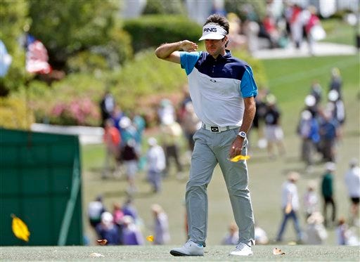 Bubba Watson shields his eyes from the wind as he walks up the first fairway during the first round of the Masters golf tournament Thursday, April 7, 2016, in Augusta, Ga. (AP Photo/Matt Slocum)
