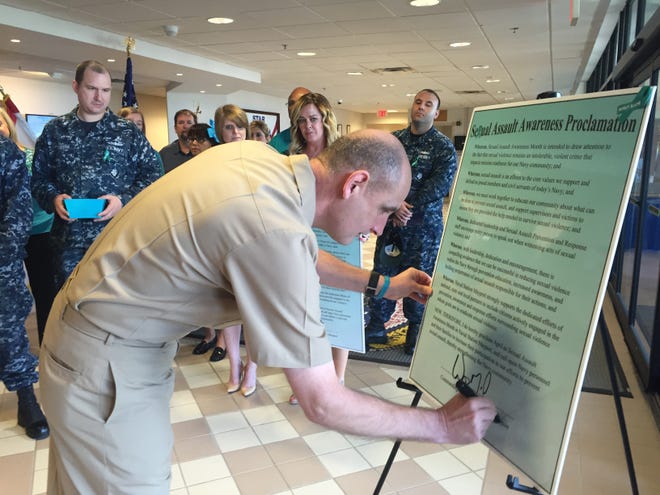 Naval Station Mayport Commanding Officer, Capt. Wes McCall, is joined by members of Fleet and Family Support Center and Command Victim Advocates in proclaiming April as Sexual Assault Awareness Month with a proclamation signing on March 31 in Building One.