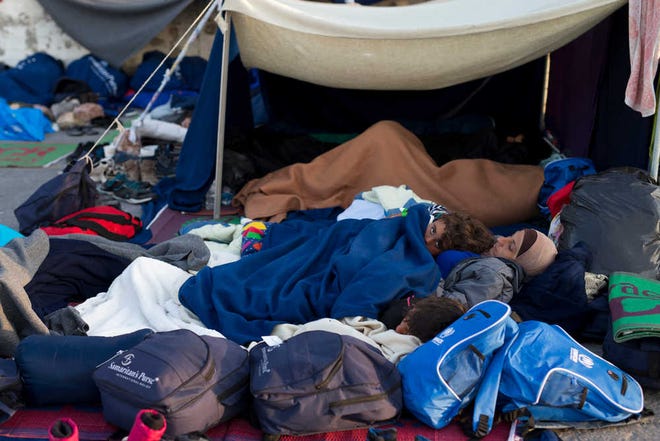 Migrants and refugees sleep at the port of the Greek island of Chios, Wednesday, April 6, 2016. On Monday, 202 migrants from 11 countries were sent back to Turkey from the Greek islands of Lesbos and Chios. The same day, 155 migrants were caught on the Aegean by the Turkish coast guard. (AP Photo/Petros Giannakouris)