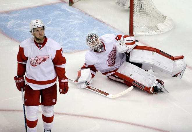 Detroit Red Wings left wing Justin Abdelkader and goalie Jimmy Howard (35) react after a goal by the Boston Bruins in the third period of an NHL hockey game, Thursday, April 7, 2016, in Boston. The Bruins won 5-2. (AP Photo/Elise Amendola)