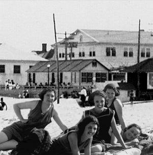 Hampton Beach bathing beauties with a rear view of the Carnival Cottage. Courtesy of the Hampton Historical Society.