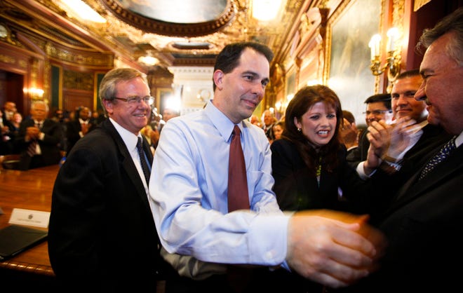 FILE - In this June 6, 2012 file photo, Wisconsin Gov. Scott Walker, second from left, and Lt. Gov. Rebecca Kleefisch are greeted by the governor's cabinet and staff at the state Capitol Madison, Wis. (AP Photo/Andy Manis, File)