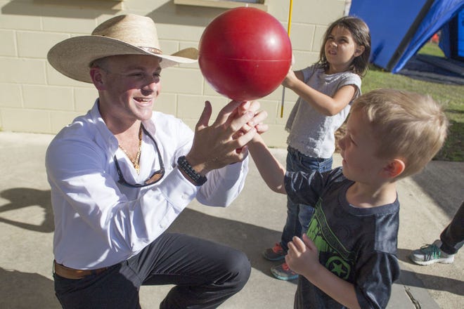 Danny Grant shows kids how to balance a spinning ball on their fingers at the Lake County Fair in Eustis on Thursday. Grant will perform his variety show every day of the fair at the main entrance.