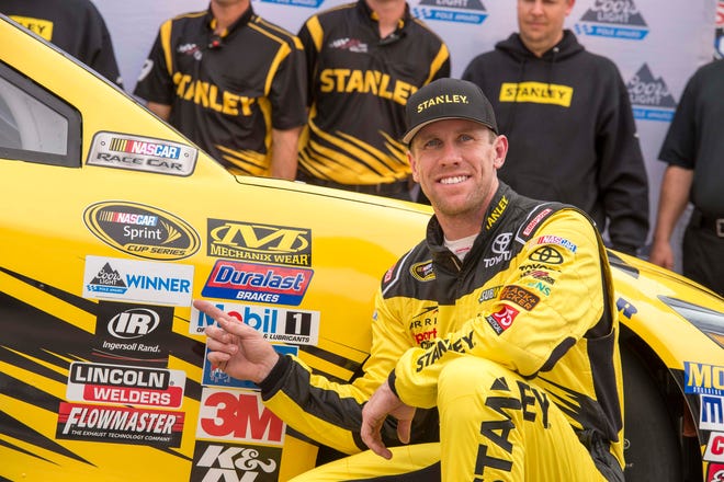 Apr 8, 2016; Fort Worth, TX, USA; Sprint Cup Series driver Carl Edwards (19) poses for a photo in victory lane after wining the pole position during qualifying for the Duck Commander 500 at Texas Motor Speedway. Mandatory Credit: Jerome Miron-USA TODAY Sports