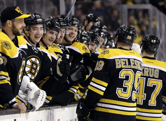 The Boston Bruins bench greets Bruins defenseman Torey Krug (47) and left wing Matt Beleskey (39) after Krug's goal on Thurday night in Boston. The Bruins beat the Red Wings 5-2 to move a win shy of clinching a playoff berth. AP Photo