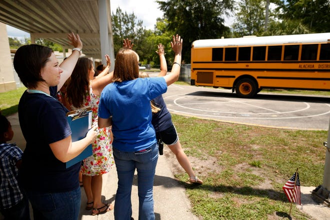 Faculty and staff at Waldo Community School wave goodbye to students during the school's last day ever Thursday, June 4, 2015. The school is closing its doors indefinitely following the school board's decision to close it.