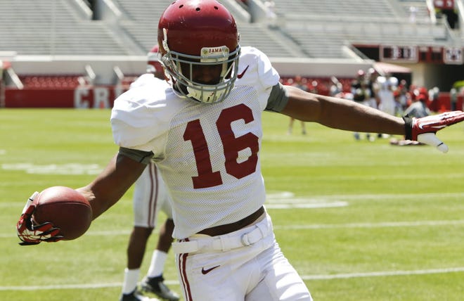 University of Alabama football players practice in Bryant-Denny Stadium Saturday, April 9, 2016 as they prepare for the annual A-Day game next Saturday. Wide receiver T.J. Simmons cruises down the sidelines after making a catch. Staff Photo/Gary Cosby Jr.