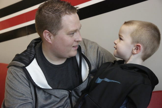 In this April 6, 2016, photo, Ed Izenstark and his son Chase, 4, talk in St. Charles, Ill. Chase Izenstark inherited a genetic predisposition to Huntington's disease from his birth father, but he only learned of his susceptibility to the fatal nerve disorder after requesting information about his adoption from a state agency last December. Illinois state Rep. Sara Feigenholtz, D-Chicago, wants to make adoption records more transparent to help thousands of people across the state access more details about their family background. (AP Photo/M. Spencer Green)