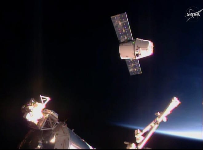 In this frame taken from video from NASA TV, the SpaceX Dragon cargo ship approaches the International Space Station Sunday. A SpaceX Dragon cargo ship arrived at the International Space Station on Sunday, two days after launching from Cape Canaveral, Florida. NASA TV image via The Associated Press