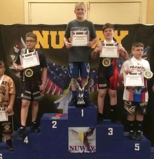 Aidan Fockler stands atop the podium at the NUWAY Nationals.