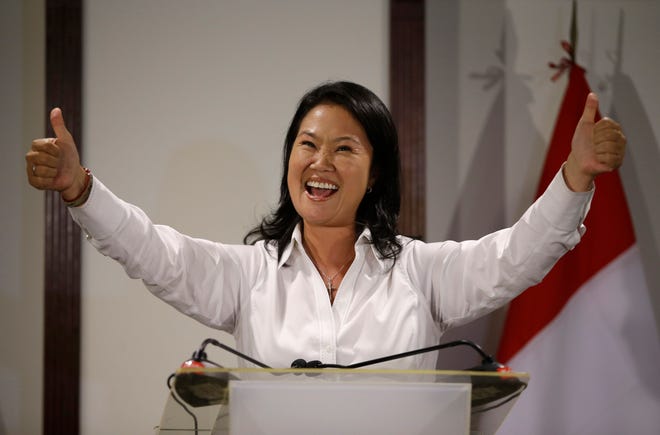Presidential candidate Keiko Fujimori, daughter of jailed former President Alberto Fujimori, gives the thumbs up during a news conference, in Lima, Peru, Sunday, April 10, 2016. Early official results in Peru's presidential election point to Fujimori emerging as the winner of the first round. Keiko Fujimori will face Pedro Pablo Kuczynski of the "Peruanos por el Kambio" political party in a June runoff. (AP Photo/Martin Mejia)